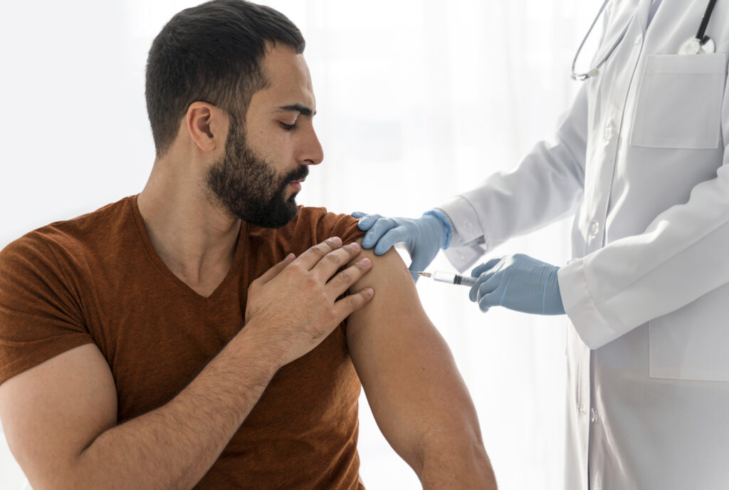 man being vaccinating by doctor