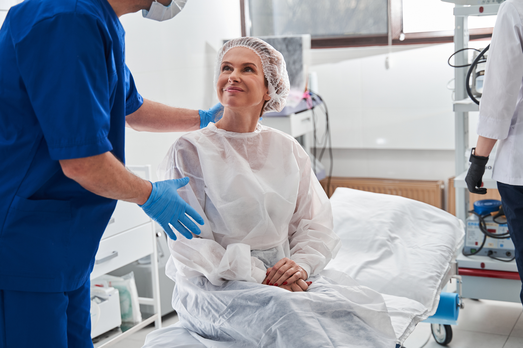 Surgeon talking to smiling patient before surgery