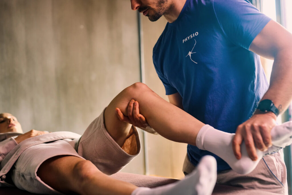 Physical therapist helping patient do leg exercise
