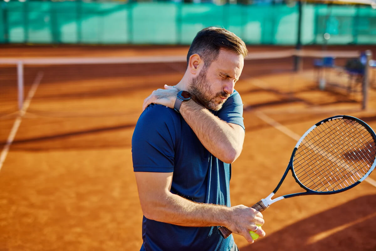 Tennis player suffering from shoulder pain during practice